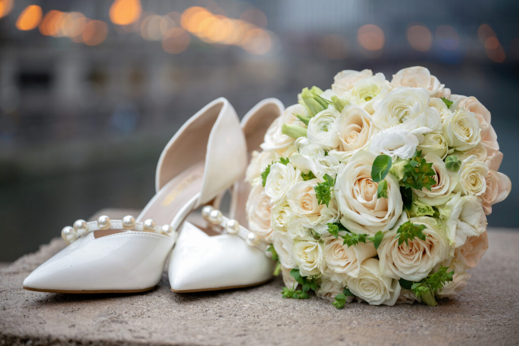 Bridal bouquet and pearl-detailed wedding shoes photographed during a Chicago winter elopement.