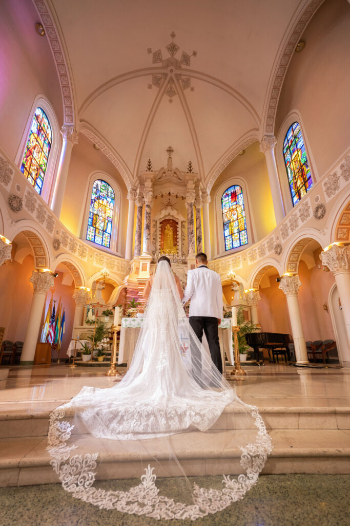 Lithuanian Catholic wedding ceremony at Nativity B.V.M. Catholic Church in Chicago with bride and groom at the altar
