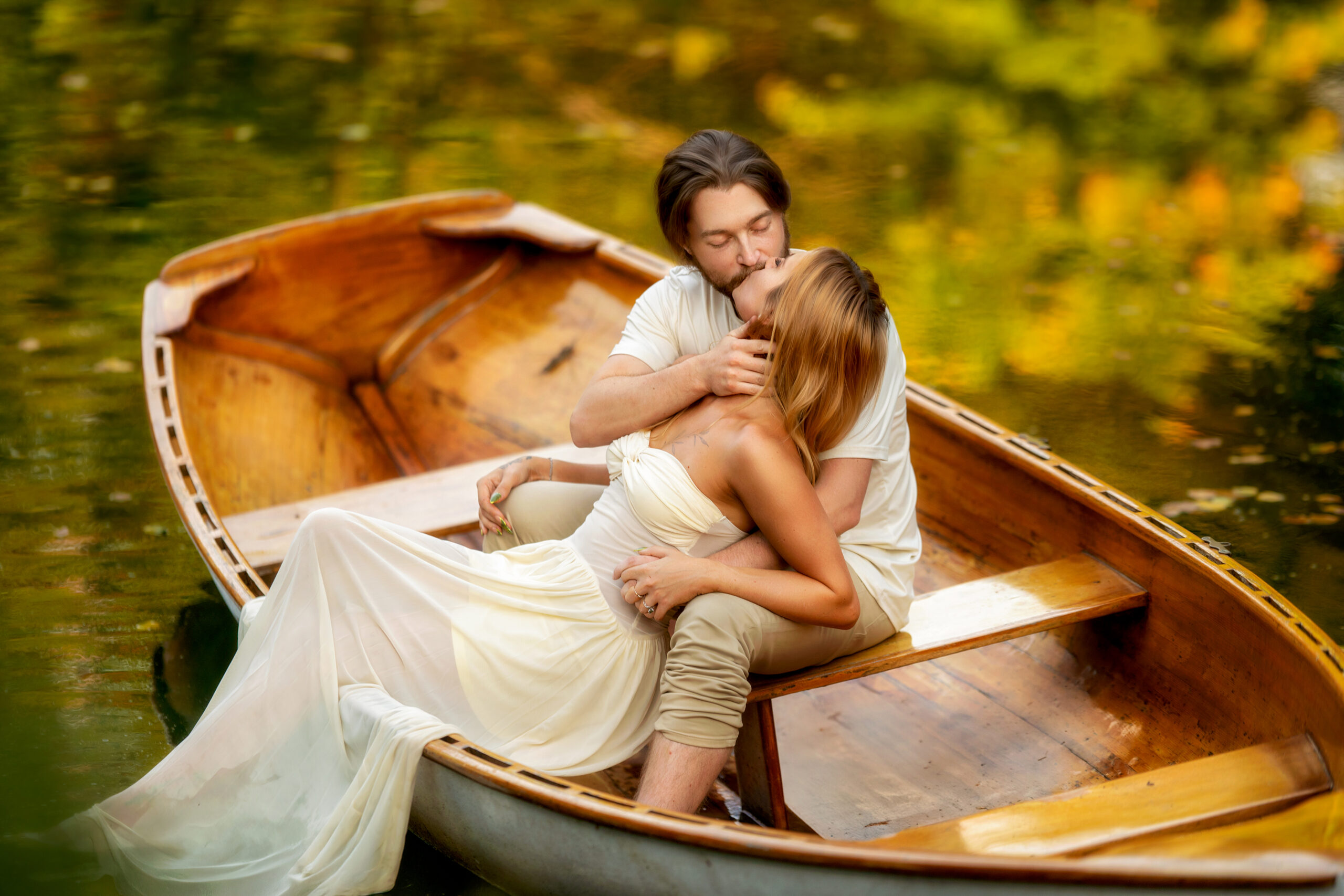 Hamstra gardens engagement photos couple kissing in boat Indiana fall session